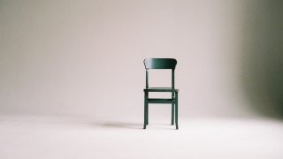 wooden chair on a white wall studio