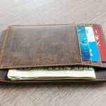 brown leather wallet and us dollar banknote