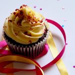 chocolate cupcake with white and red toppings