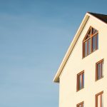 beige concrete house under cumulus cloud
